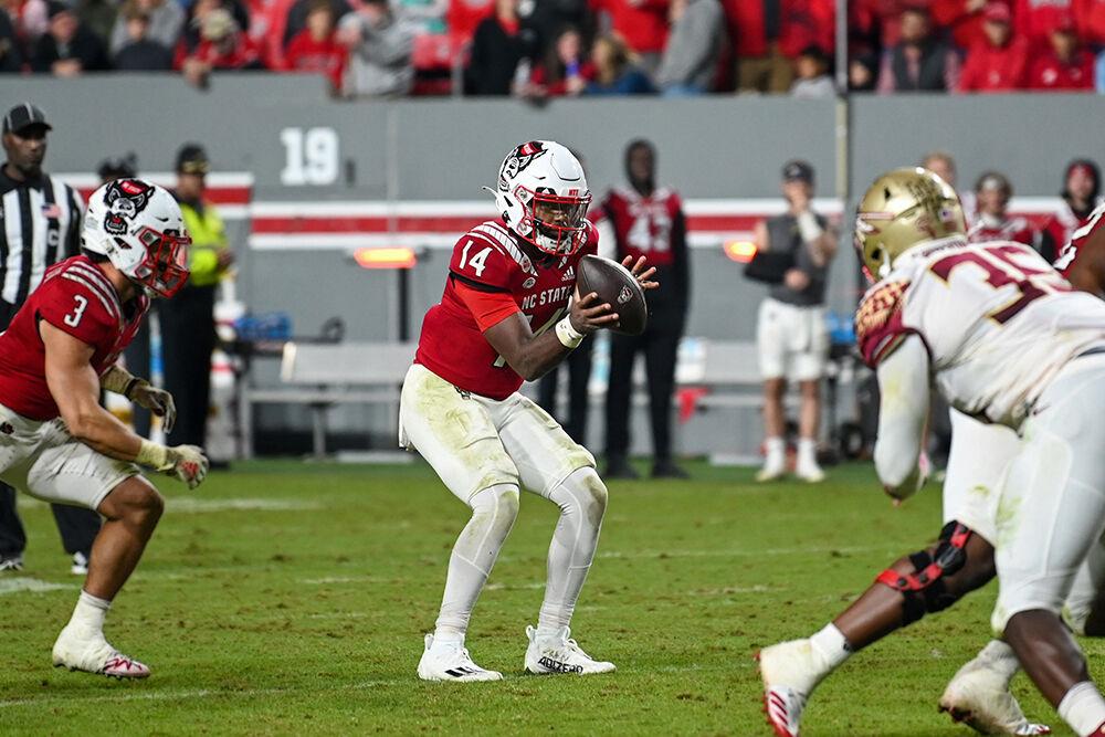 Graduate quarterback Jack Chambers catches the hike in the game against Florida State University at Carter-Finley Stadium on Saturday, Oct. 8, 2022. The Wolfpack beat the Seminoles 19-17.