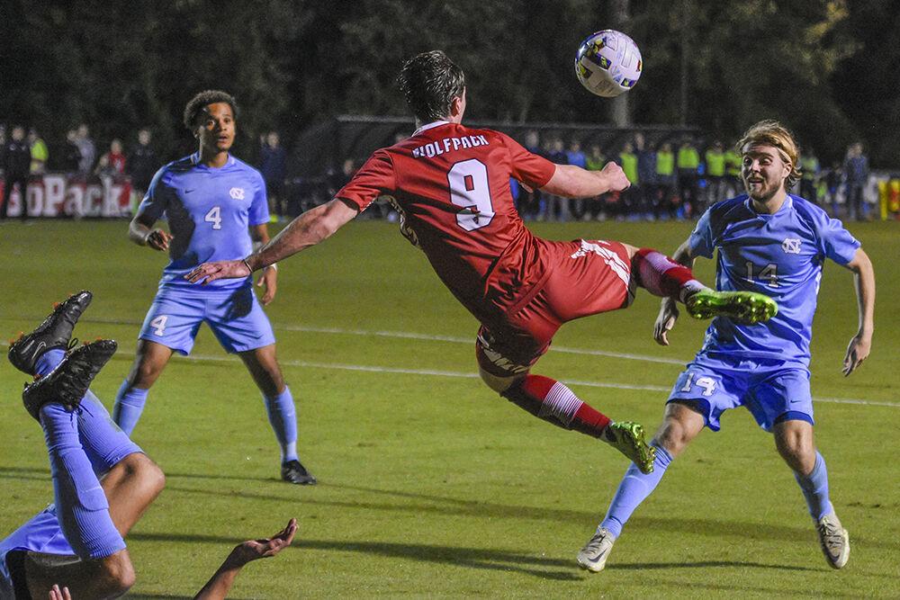 Sophomore forward Luke Hille jumps to kick the ball during the match against UNC-Chapel Hill on Friday,&#160;Oct. 14, 2022 at Dail Soccer Field. Hille had one shot on goal. NC State tied 2-2 with&#160;UNC-Chapel Hill.