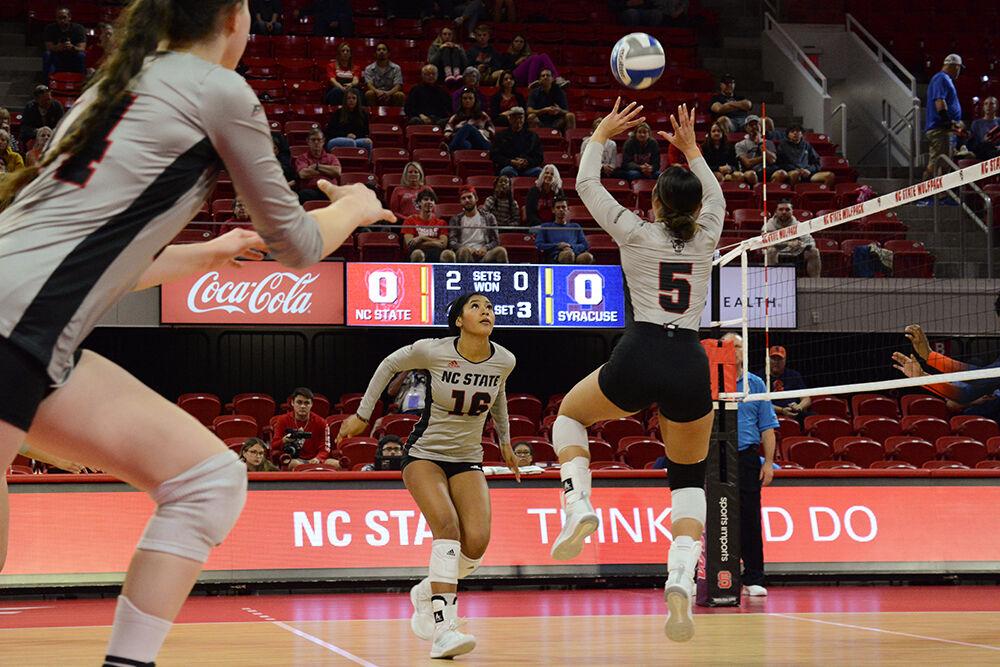 Senior setter Kristen McDaniel sets the ball to sophomore middle blocker Jada Allen at the volleyball game against Syracuse on Friday, Oct. 14, 2022 in Reynolds Coliseum. McDaniel had 17 assists, Allen scored 8.5 points and the Wolfpack beat the Orange 3-0.