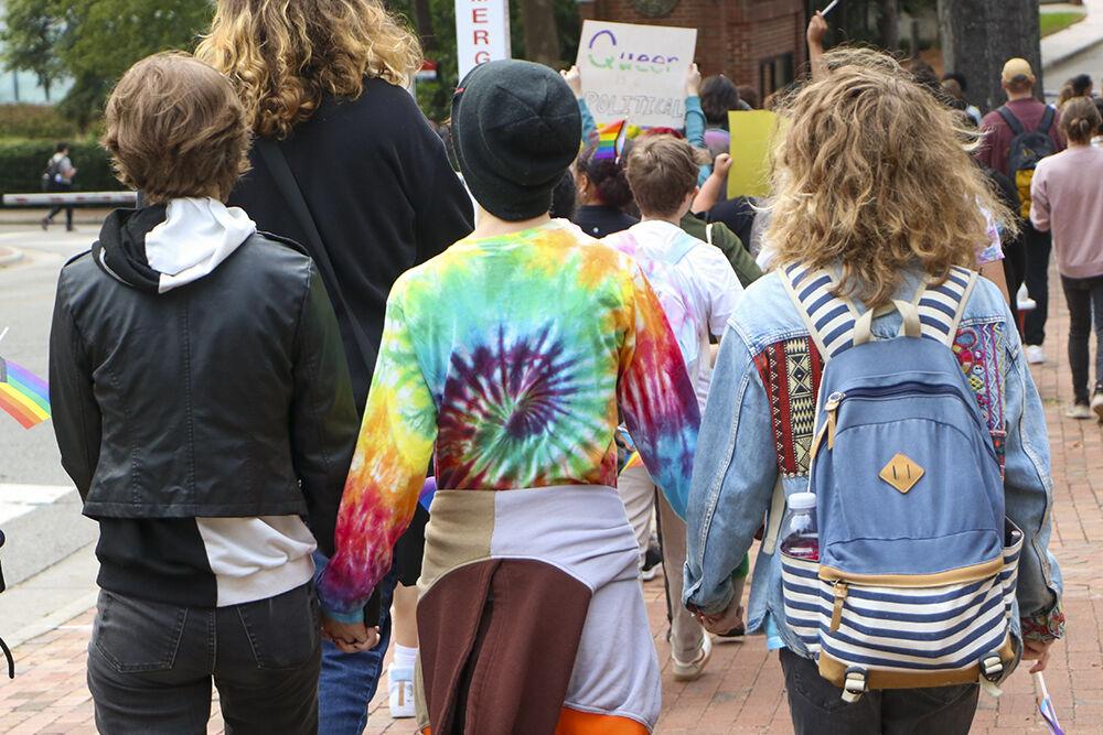 Members of the NC State community hold hands during the Pride Walk on Monday, Oct. 3, 2022 around main campus. The Pride Walk allowed students express themselves with no judgement.