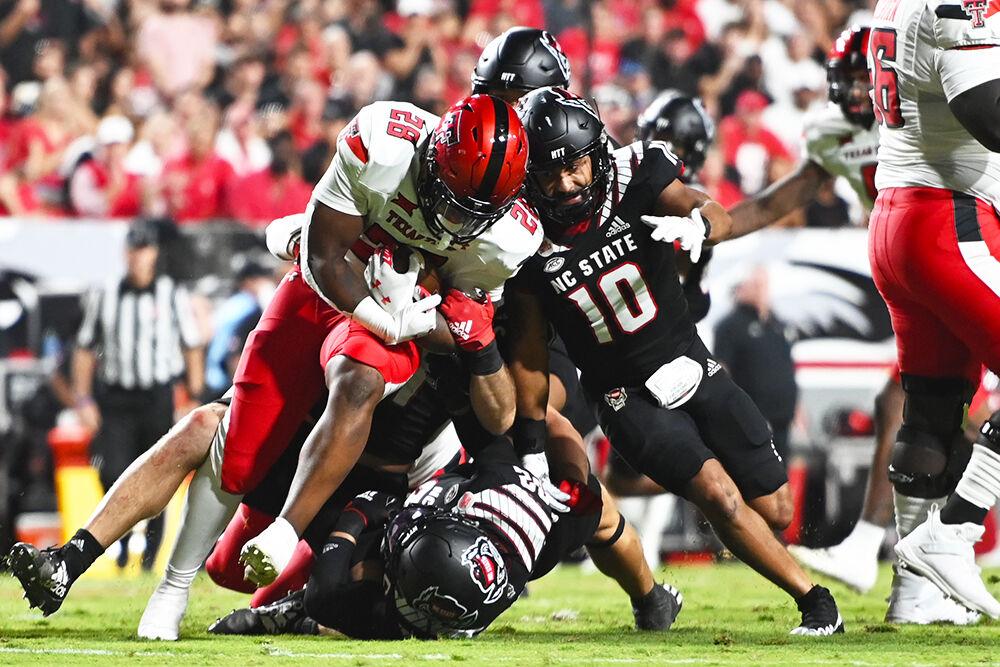 Senior safety Tanner Ingle tackles a Texas Tech Raider during the game at Carter-Finley Stadium on Saturday, Sept. 17, 2022. The Wolfpack won 27-14.