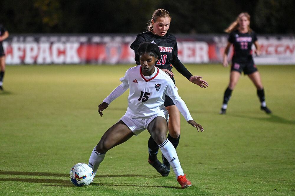 Senior forward Jameese Joseph dribbles the ball away from an opponent during the match against Louisville on Thursday, Oct. 20, 2022 at Dail Soccer Field. NC State lost 1-0 to Louisville.