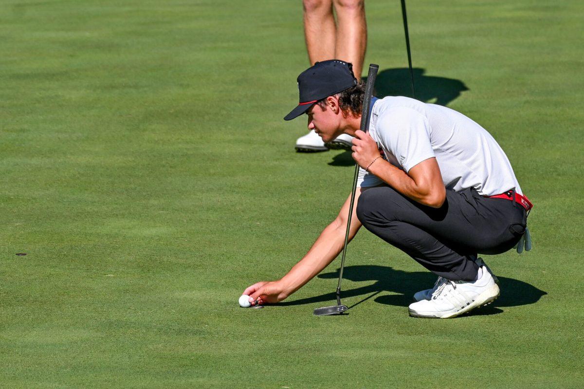 Freshman Joey Lenane lines up his ball on the green during the Wolfpack Intercollegiate tournament on Saturday, Oct. 15, 2022. Lenane had a score of 6-over. NC State tied for second place.