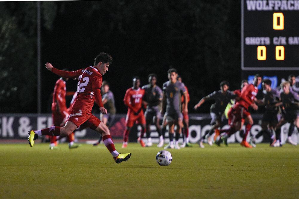 Graduate midfielder Conor Kelly kicks the ball during the Wolfpack's home soccer match against the William &amp; Mary Tribe on Tuesday, Oct. 18, 2022 at Dail Soccer Field. The Wolfpack beat the Tribe 2-1.