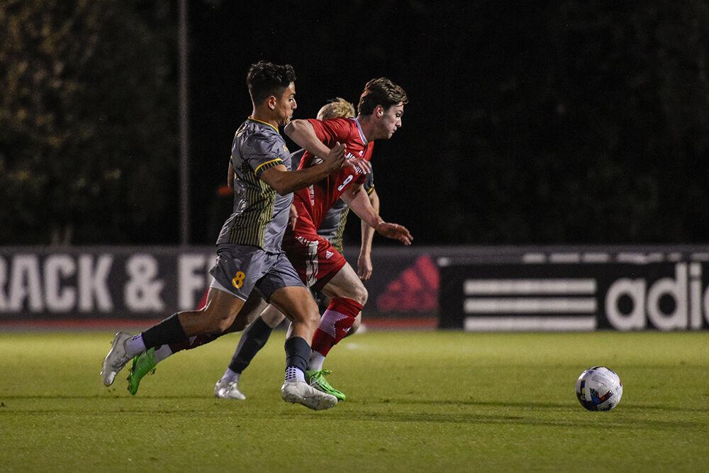 Sophomore forward Luke Hille fights for the ball during the Wolfpack's home soccer match against the William &amp; Mary Tribe on Tuesday, Oct. 18, 2022 at Dail Soccer Field. The Wolfpack beat the Tribe 2-1.