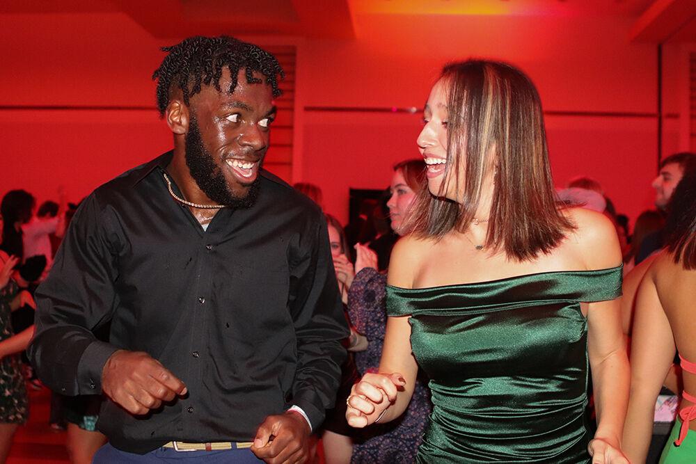(Left) Robin Batsuli, a fourth-year studying business IT and Maria Echeverry Montano, a third-year studying political science, dance to the Cupid Shuffle at the Red and White Ball in Talley Student Union on Saturday, Oct. 22, 2022.