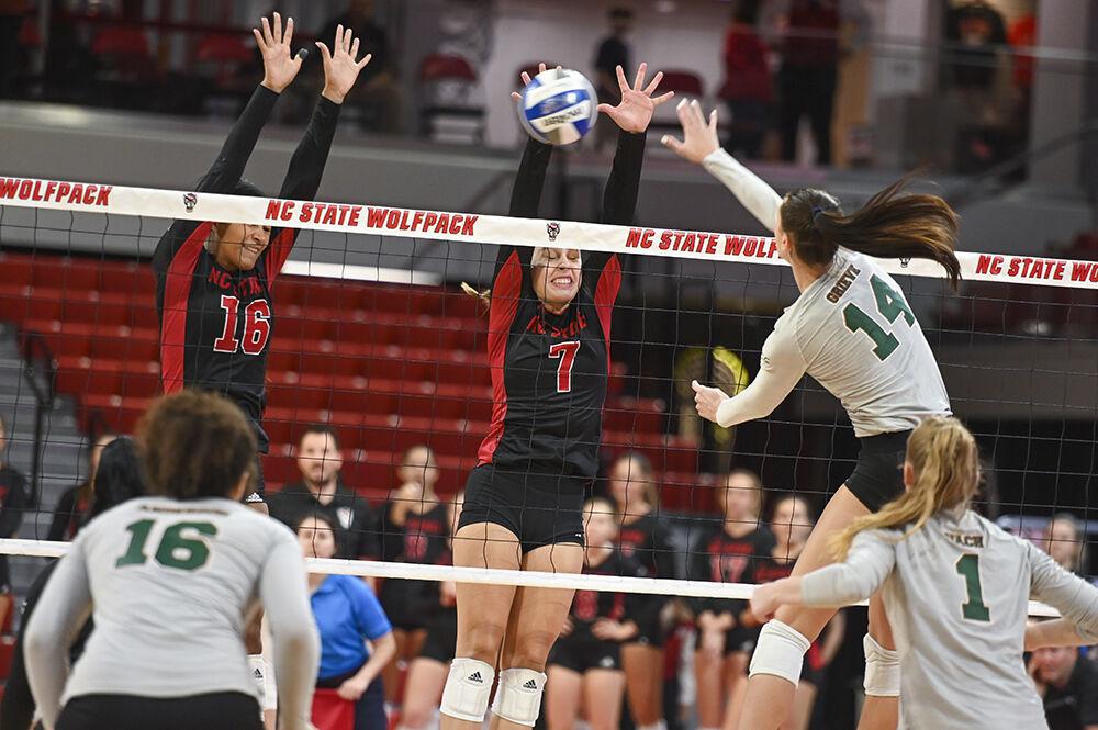 Sophomore middle blocker Jada Allen and freshman outside hitter block the ball during the game against Miami on Sunday, Oct. 2, 2022 at Reynolds Coliseum. The Wolfpack beat the Hurricanes 3-1.