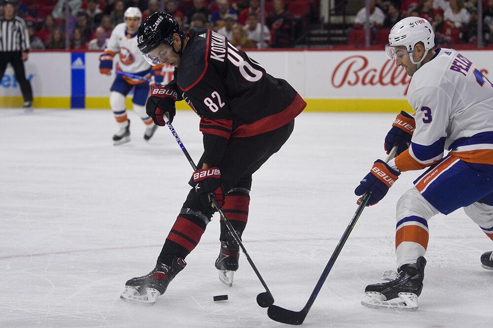 Center Jesperi Kotkaniemi fights for the puck during the game against the New York Islanders in PNC Arena on Friday, Oct. 28, 2022. Kotkaniemi had one takeaway. The Hurricanes lost 6-2.