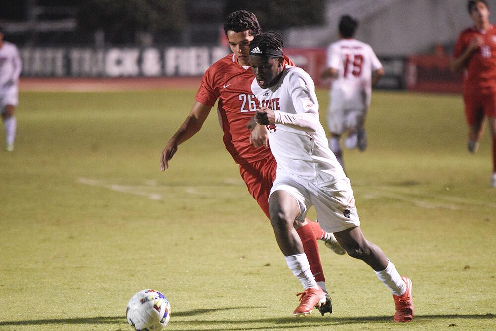 Junior forward Junior Nare dribbles past a Radford player during the match against Radford on Tuesday, Oct.&#160;25, 2022 at Dail Soccer Field. The NC State game versus Radford was the last home game of the 2022 Men&#8217;s Soccer regular season. NC State beat Radford 2-0.