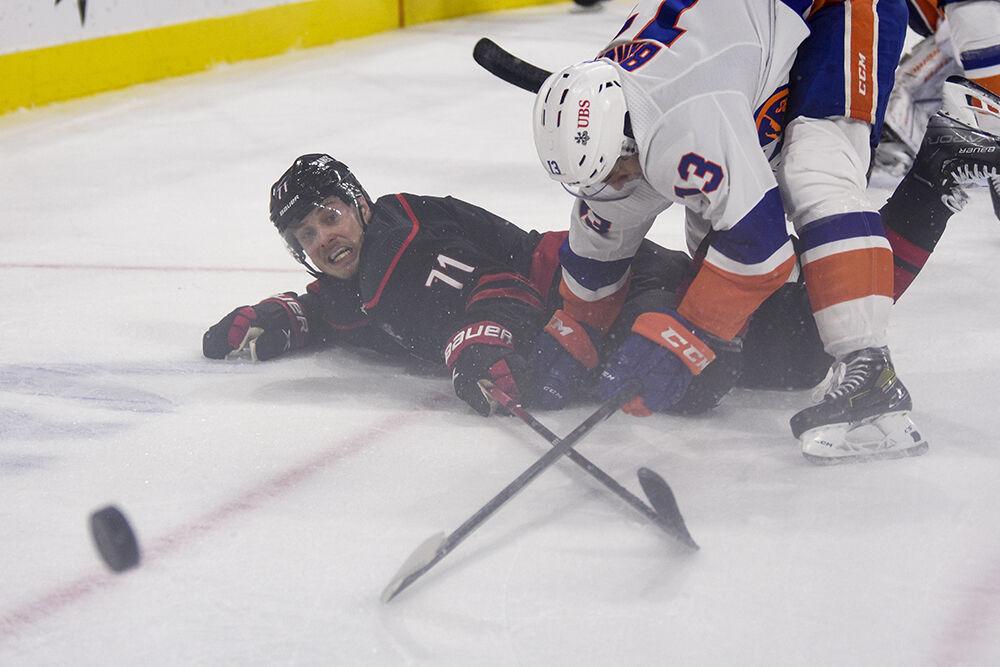 Right wing Jesper Fast fights for the puck during the game against the New York Islanders in PNC Arena on Friday, Oct. 28, 2022. Fast had two shots. The Hurricanes lost 6-2.