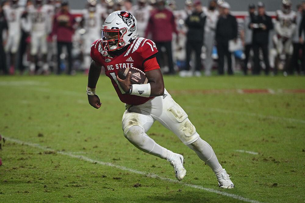 Graduate quarterback Jack Chambers runs the ball during the Wolfpack's home football game against the Florida State Seminoles on Saturday, Oct. 8, 2022 at Carter-Finley Stadium. The Wolfpack beat the Seminoles 19-17. Chambers came in after starting quarterback Devin Leary went down with a shoulder injury.
