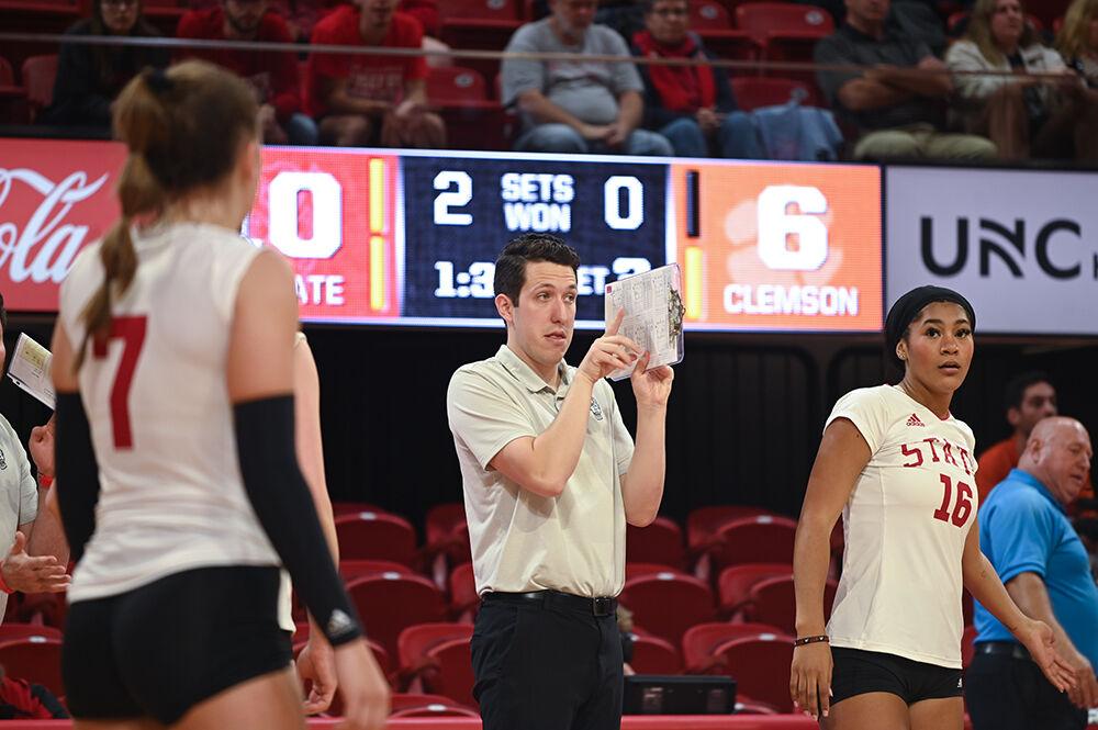 Assistant coach Jeremiah Gonidakis makes a call during the game against Clemson on Friday, Oct. 28, 2022 in Reynolds Coliseum. NC State won the game 3-0 against Clemson.