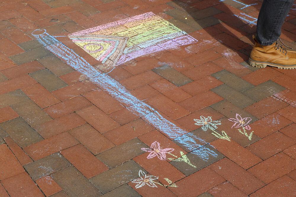 Students create artwork on the outdoor brick during the Pride Walk on Monday, Oct. 3, 2022 around main campus. NC State's pride community celebrated their Second Annual Pride Walk.