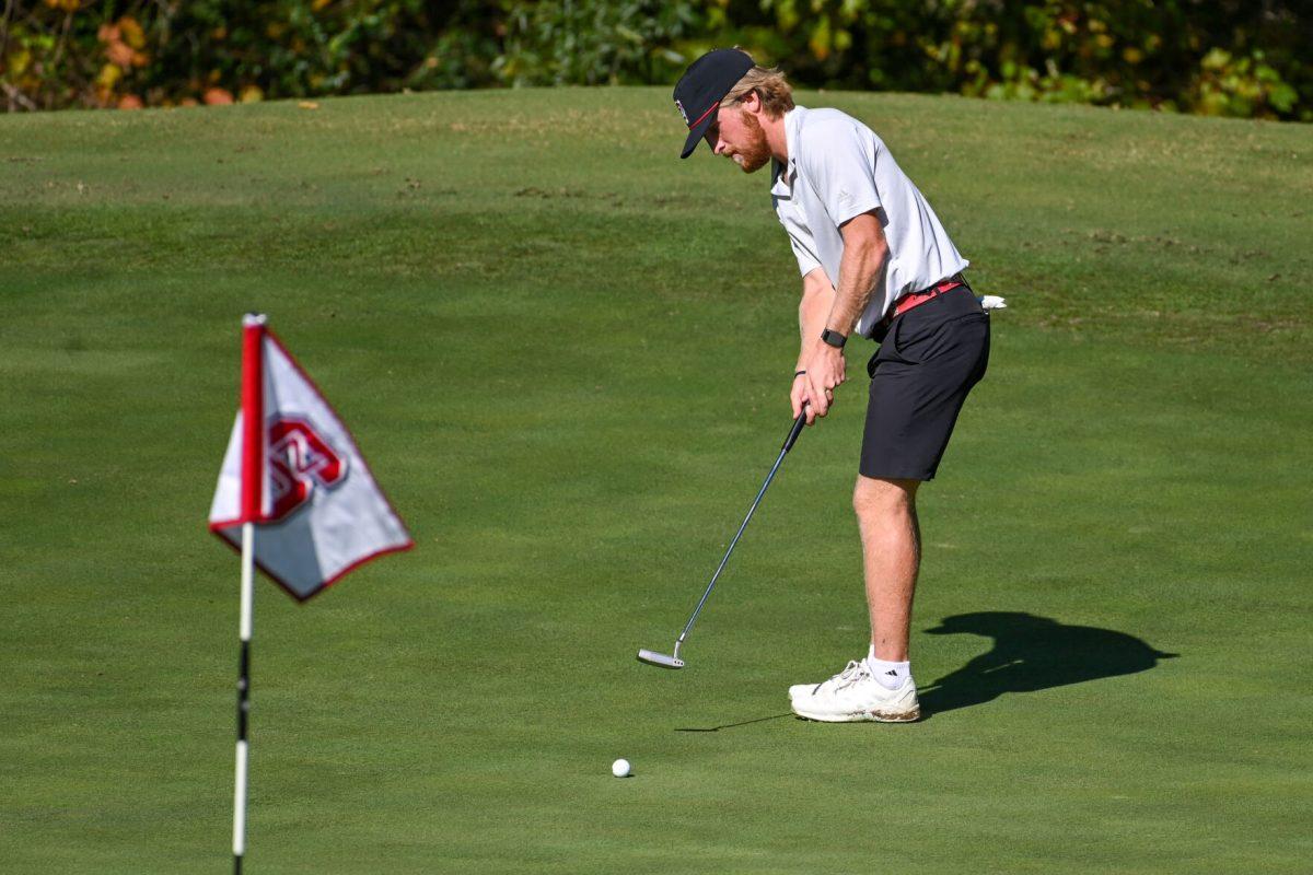 Senior Carter Graf putts the ball during the Wolfpack Intercollegiate tournament on Saturday, Oct. 15, 2022 at Lonnie Poole Golf Course. Graf had a score of 1-under. NC State tied for second place.