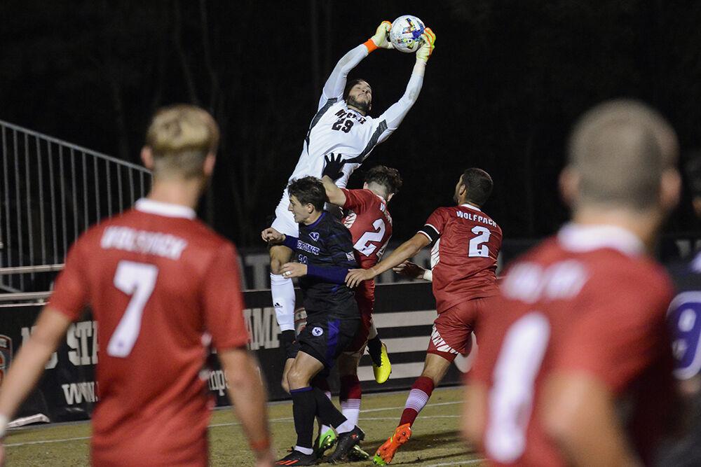 Sophomore goalkeeper Lucas Hatsios saves the ball from an attack on the goal during the match against High Point University on Tuesday, Oct. 4, 2022 at Dail Soccer Field. Hatsios made three saves for the Wolfpack. NC State beat High Point University 2-0.