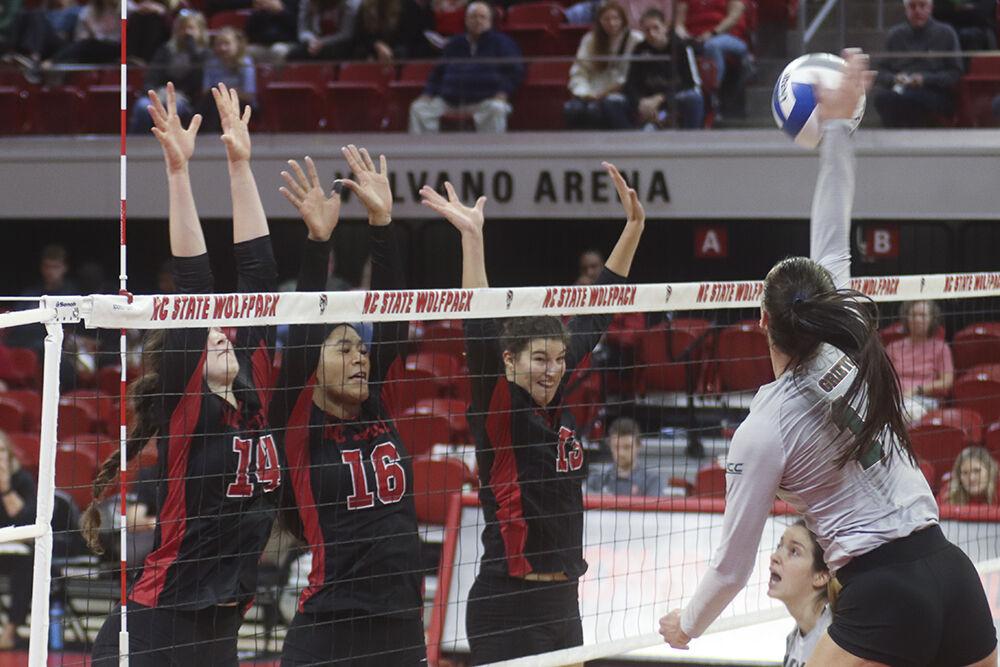 Outside hitter Martyna Leoniak (left), middle blocker Jada Allen (middle), and opposite hitter Vanja Bukilic (right) jump to block their opponent's spike during the match against Miami on Sunday,&#160;Oct. 2, 2022 in Reynolds Coliseum. The Wolfpack beat the Hurricanes 3-1.
