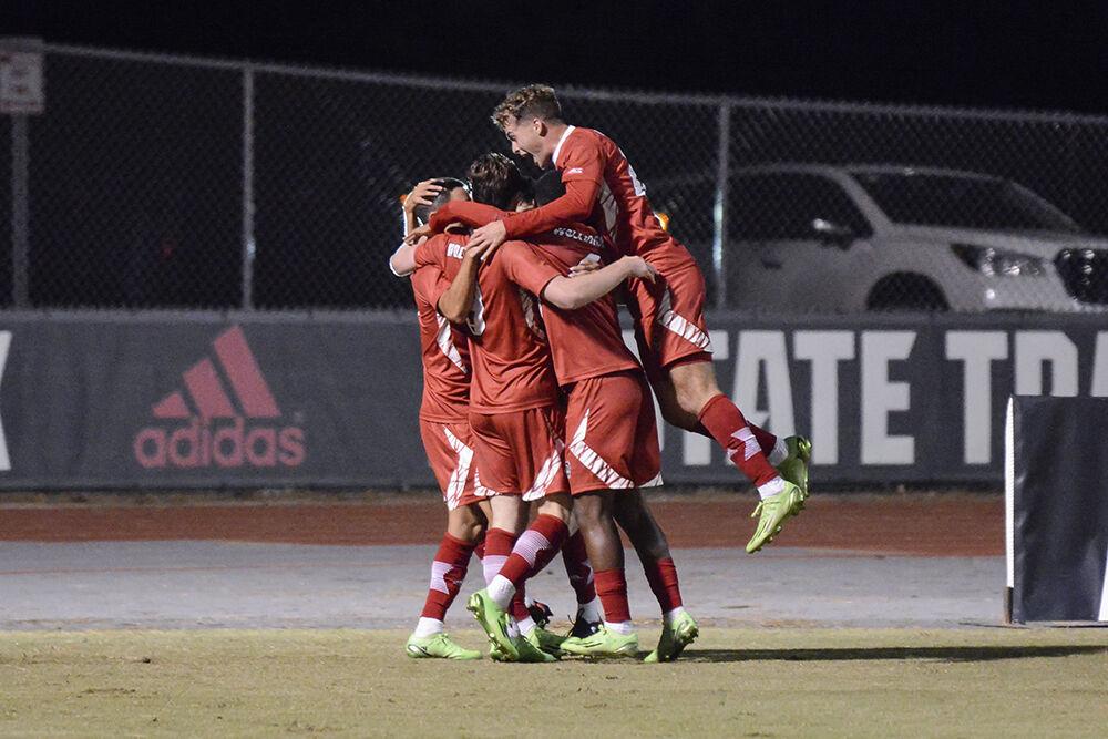 Freshman midfielder Drew Lovelace jumps on his teammates to celebrate a goal scored during the match against High Point University on Tuesday, Oct. 4, 2022 at Dail Soccer Field. NC State beat High Point University 2-0.