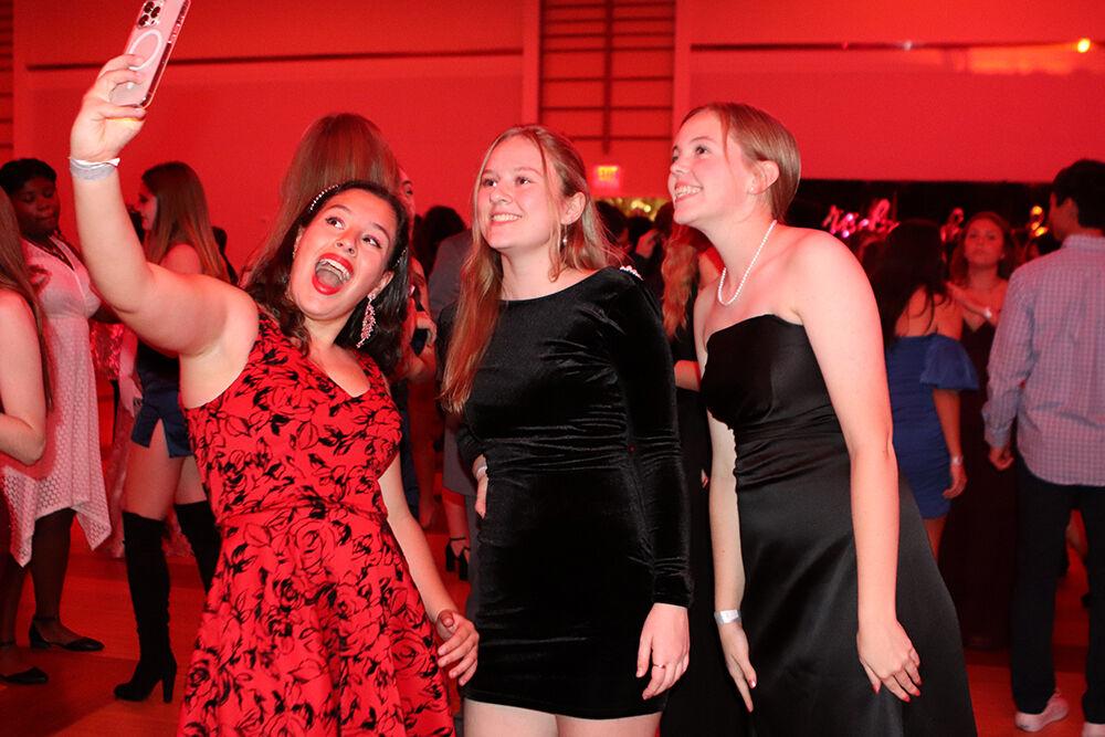 (From left) Lily Mersel, a first-year studying genetics, Chloe Cernoch, a second-year studying biomedical engineering and Laynie McCall, a second-year studying criminology, take a selfie at the Red and White Ball in Talley Student Union on Saturday, Oct. 22, 2022.