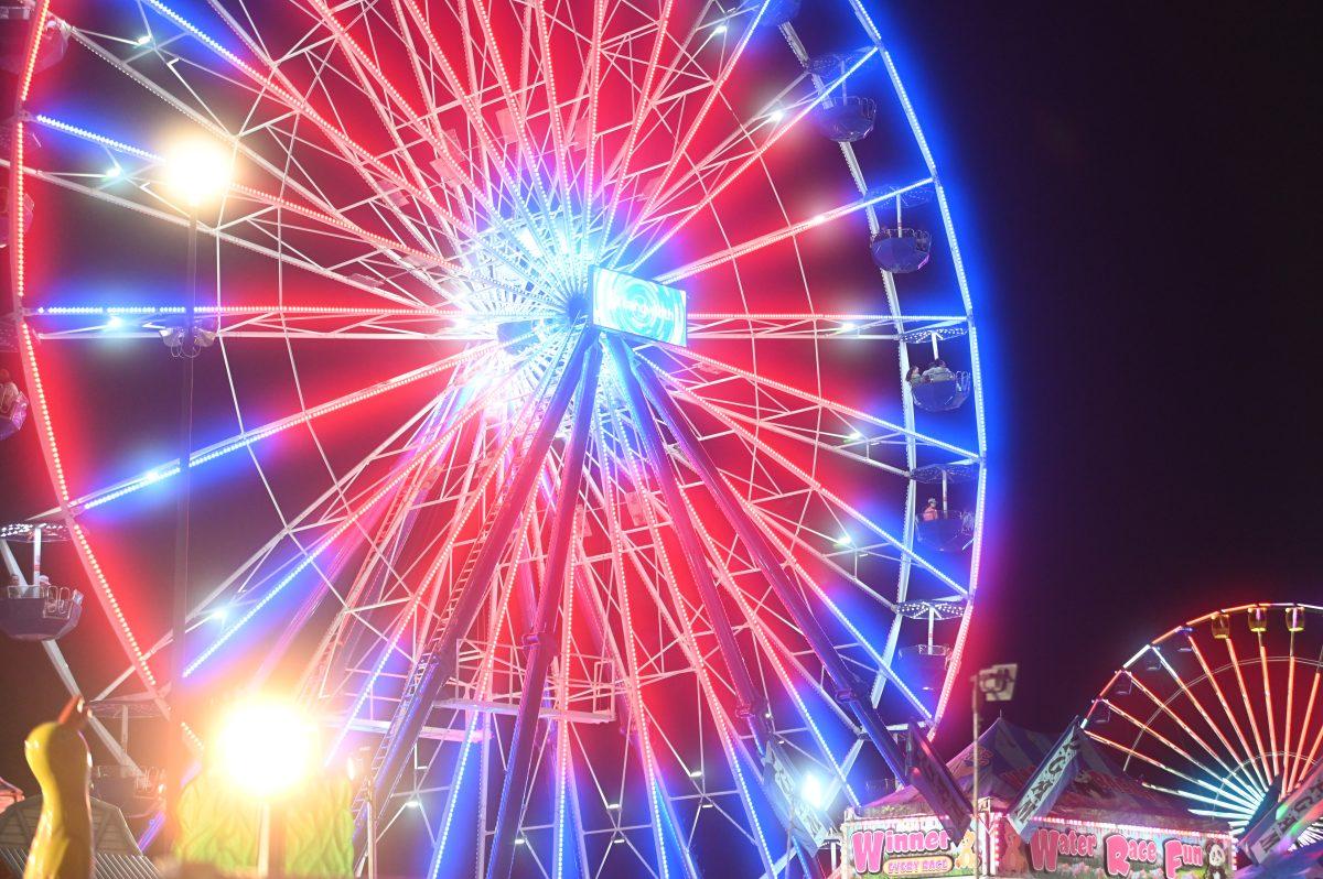 Fair Attendees ride a Ferris Wheel at the North Carolina State Fair in Raleigh, on Thursday, Oct. 13, 2022. The NC State Fair was held Oct. 13-23.