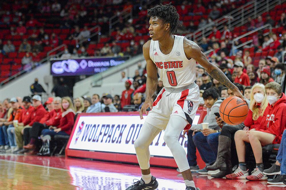 Freshman guard Terquavion Smith looks for a teammate during the game against Virginia on Saturday, Jan. 22, 2022 at PNC Arena. Smith made four 3-pointers for the Wolfpack. The Wolfpack beat the Cavaliers 77-63.