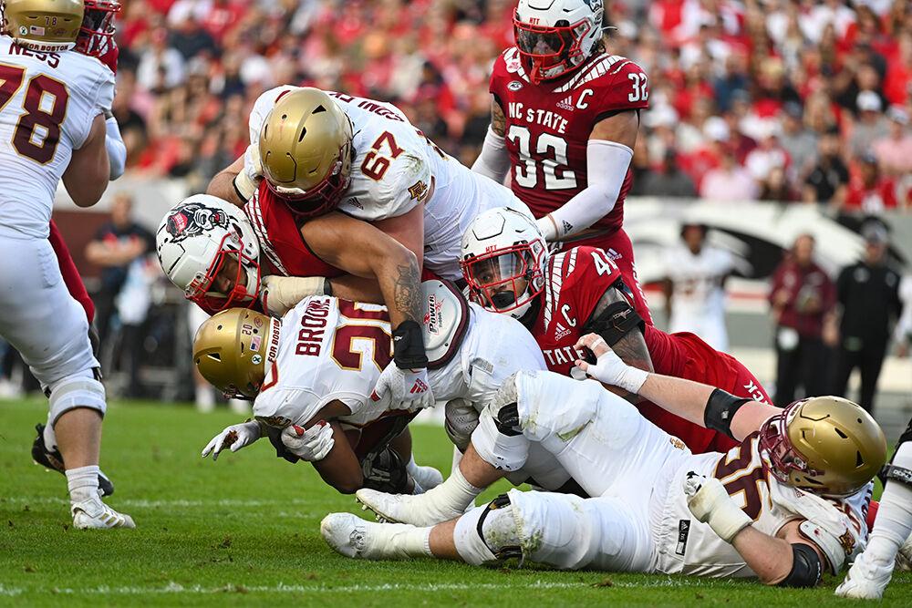 The NC State defense tackles a Boston College running back during the game against Boston College on Saturday, Nov. 12, 2022 in Carter-Finley Stadium. NC State lost to Boston College 21-20.
