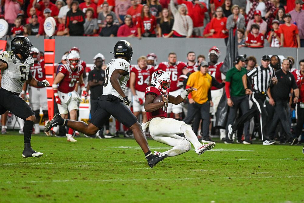 Freshman Quarterback M.J. Morris slides after scrambling in the NC State victory over Wake Forest. NC State defeated Wake Forest 30-21 on Saturday, Nov. 5, 2022 at Carter Finley Stadium. Morris passed for 210 yards and three touchdowns in the win.