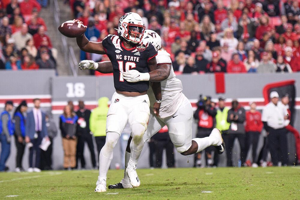 Freshman quarterback MJ Morris runs down the field during the Wolfpack's game against the Virginia Tech Hokies on Thursday, Oct. 27, 2022 at Carter-Finley Stadium. The Wolfpack beat the Hokies 22-21.