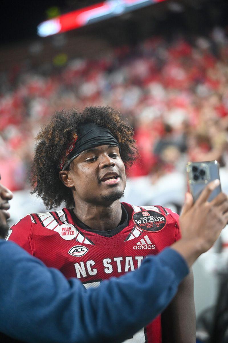 Freshman quarterback MJ Morris films a video after leading NC State to a victory over Wake Forest on Saturday, Nov. 5, 2022 at Carter-Finley Stadium. Morris passed for 210 yards and three touchdowns in the win.&#160;NC State defeated Wake Forest 30-21.