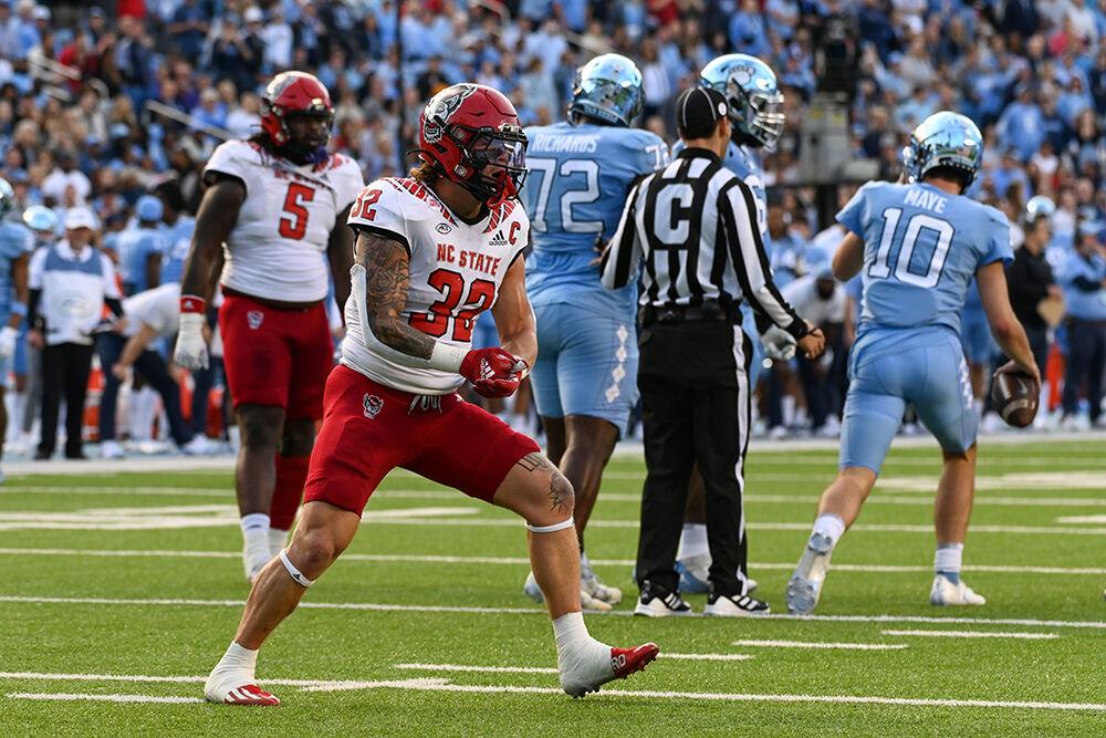 Junior linebacker Drake Thomas celebrates his sack of Tar Heel quarterback Drake Maye during the Wolfpack's last regular season football game against the UNC-Chapel Hill Tar Heels at Kenan Memorial Stadium on Friday, Nov. 25, 2022. The Wolfpack beat the Tar Heels in double overtime 30-27.