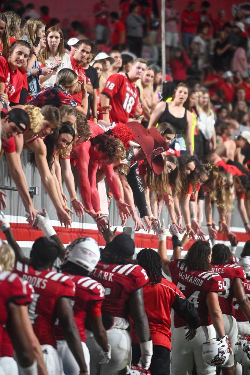 The NC State football team high five fans after the victory over Wake Forest&#160;on Saturday, Nov. 5, 2022 at Carter-Finley Stadium.&#160;NC State defeated Wake Forest 30-21.