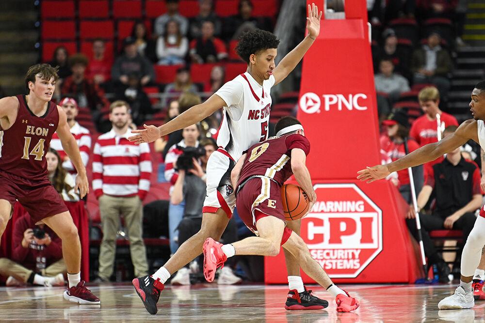 Graduate student guard Jack Clark guards an opponent during the game against Elon in PNC Arena on Saturday, Nov. 19, 2022. Clark led the Wolfpack's scoring with 21 points. The Wolfpack won 74-63.