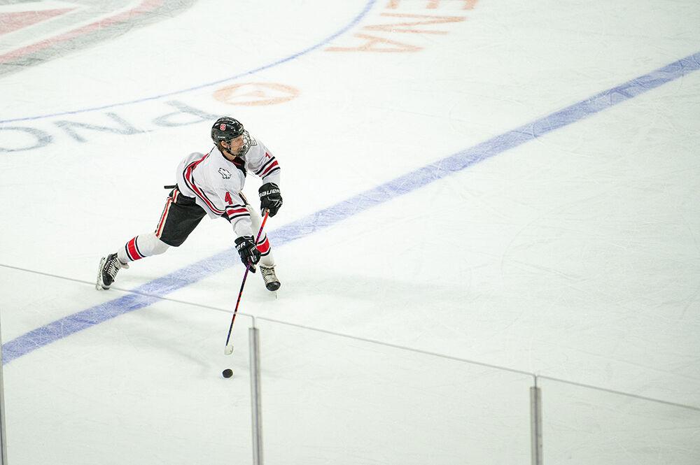 Junior forward Jackson Cowen shoots the puck down the ice during the Governor's Cup game against the UNC Tar Heels on Monday, Nov. 21, 2022&#160;in PNC Arena. The Icepack lost to the Tar Heels 4-2.