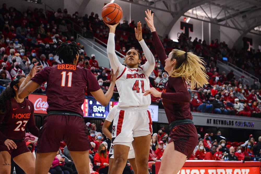 Junior center Camille Hobby shoots the ball around the block in the game against Virginia Tech on Sunday, Jan. 23, 2022 in Reynolds Coliseum. Hobby scored six points and contributed three rebounds. NC State beat Virginia Tech 51-45.