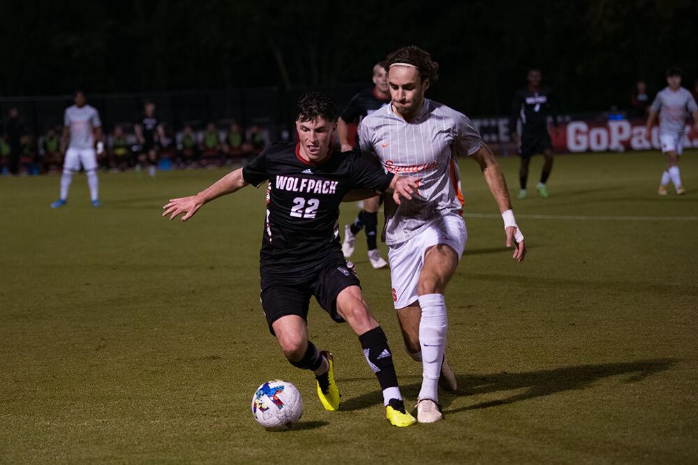 Graduate midfielder Conor Kelley defends the ball against an opposing player in the game against Syracuse on Saturday, Oct. 22, 2022. at Dale Soccer Field. The Wolfpack tied with Syracuse 1-1.