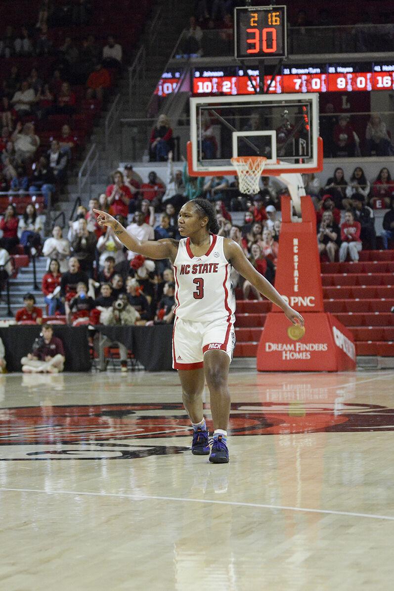 Junior guard Diamond Johnson points to her teammates during the game against Elon at Reynolds Coliseum on Thursday, Nov. 10, 2022. Johnson led the team in scoring with 18 points on 63.6% shooting. NC State beat Elon 89-55.