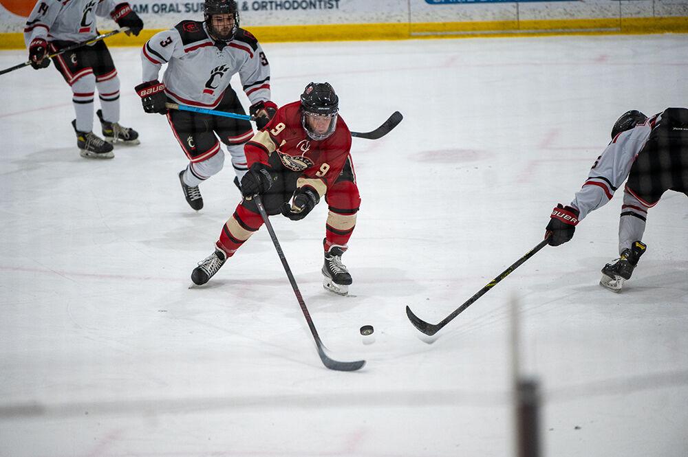 Freshman forward Thomas McEneny retrieves the puck during the game against Cincinnati Bearcats at Wake Competition Center on Saturday, Nov. 19, 2022. The Icepack beat the Bearcats 4-3.