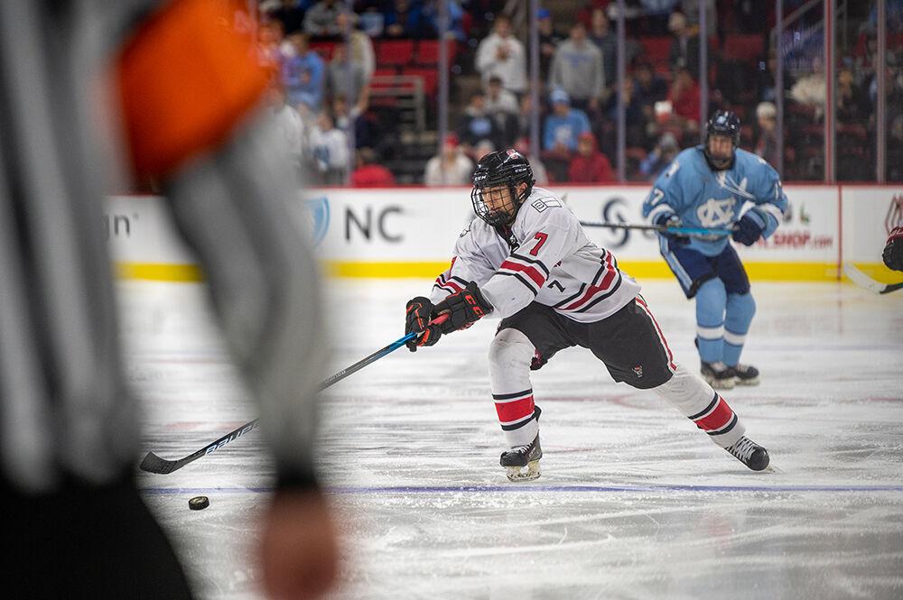 Sophomore forward Zack Robinson retrieves the puck while moving down the ice during the Governor's Cup game against the UNC Tar Heels on Monday, Nov. 21, 2022&#160;in PNC Arena. The Icepack lost to the Tar Heels 4-2.
