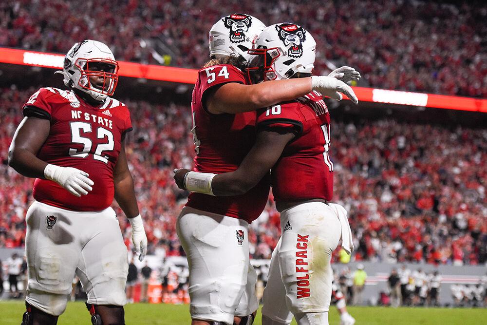 Redshirt sophomore offensive lineman Dylan McMahon (left) hugs freshman quarterback MJ Morris (right) during the game against Wake Forest on Saturday, Nov. 5, 2022 at Carter-Finley Stadium.&#160;The Wolfpack beat the Demon Deacons 30-21.