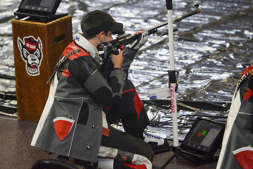 Sophomore Ben Salas aims at a target at the NC State versus West Virginia rifle match at Reynolds Coliseum on Sunday, Oct. 17, 2021. NC State lost&#160;4730-4652 against West Virginia.
