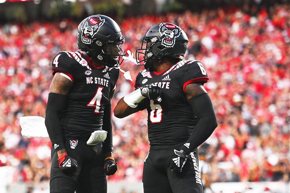 Junior safety Jakeen Harris and graduate student safety Cyrus Fagan celebrate a third-down stop at the game against the Texas Tech Red Raiders at Carter-Finley Stadium on Saturday, Sept. 17, 2022. The Wolfpack won 27-14.