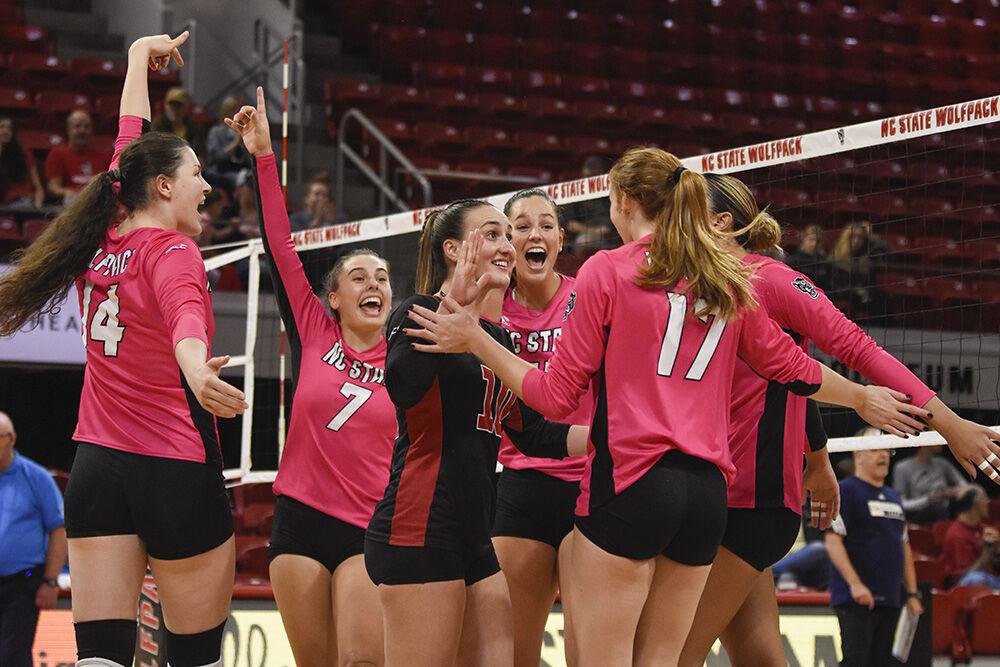 The NC State volleyball team celebrates a point against Georgia Tech on Sunday, Oct. 30, 2022 in Reynolds Coliseum. The Wolfpack lost to the Yellow Jackets 3-1.