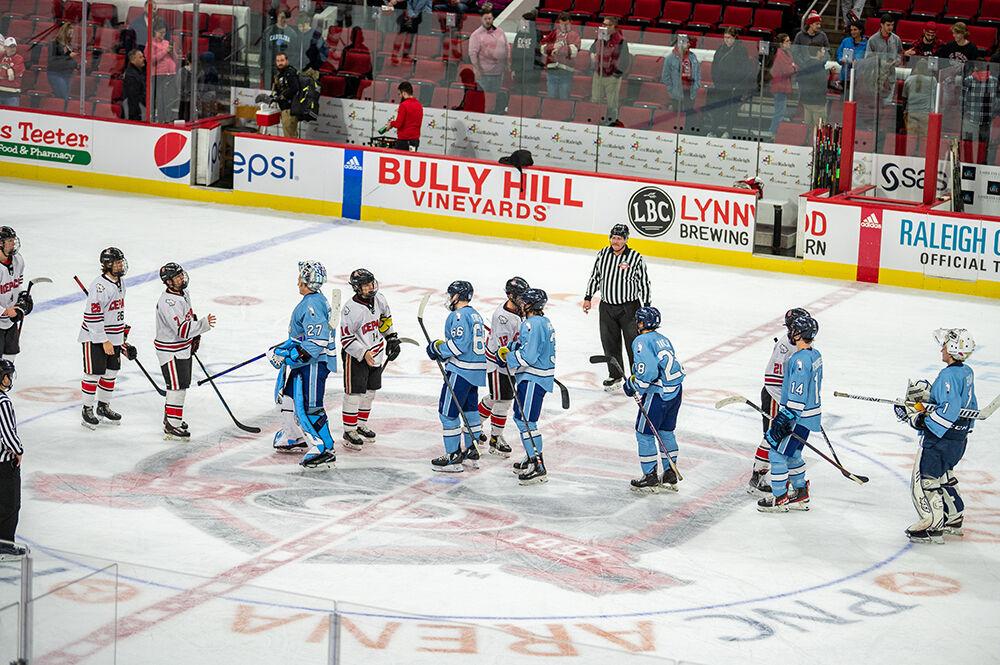 The Icepack team members shake hands with the opposing team at the end of the Governor's Cup game against the UNC Tar Heels on Monday, Nov. 21, 2022&#160;in PNC Arena. The Icepack lost to the Tar Heels 4-2.