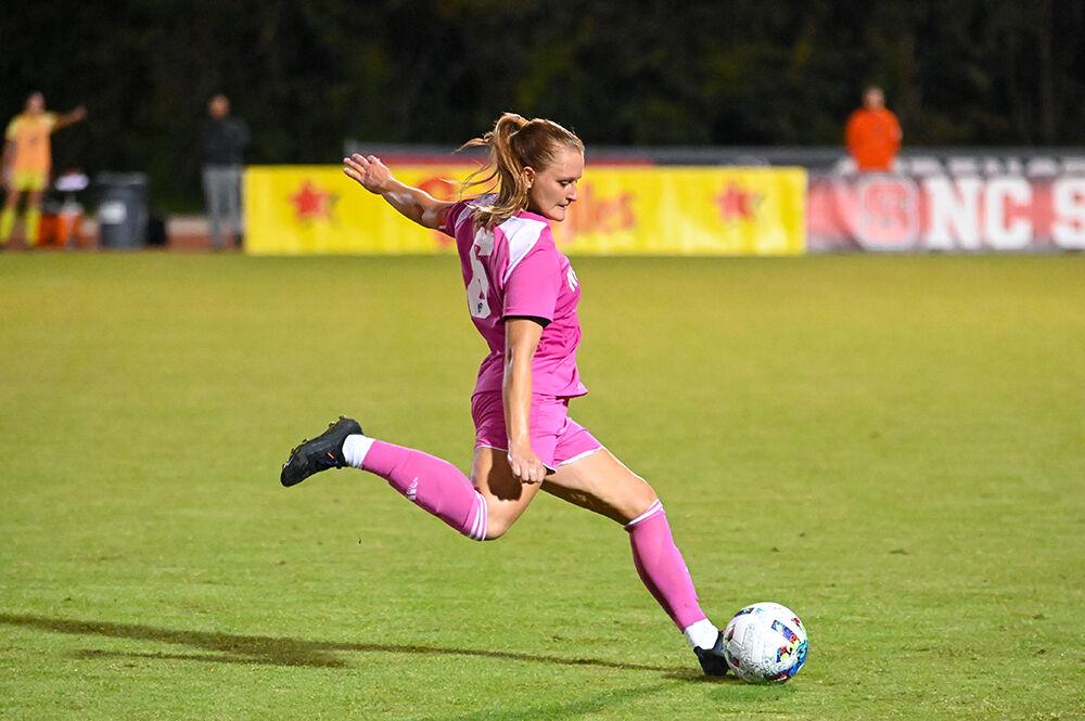 Graduate defender Lulu Guttenberger aims to kick the ball during the match against Miami on Saturday, Oct. 15, 2022 at Dail Soccer Field. Guttenberger scored two goals for the Wolfpack. NC State and Miami tied 3-3.