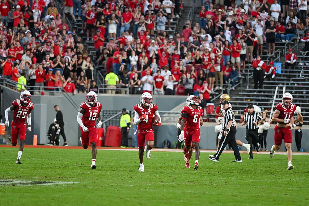 Redshirt graduate safety Cyrus Fagan celebrates with the team after intercepting a pass on Saturday, Nov. 12, 2022 at Carter Finley Stadium. Fagan had eight tackles and one tackle for loss in the game. NC State lost to Boston College 21-20.