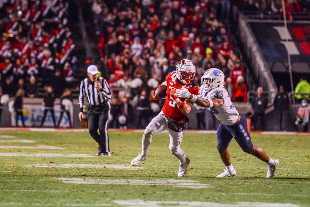 Junior wide receiver Thayer Thomas outruns a Tar Heel defender during the last home football game of the season against the UNC-Chapel Hill at Carter-Finley Stadium on&#160;Friday, Nov. 26, 2021. The Wolfpack won 34-30.