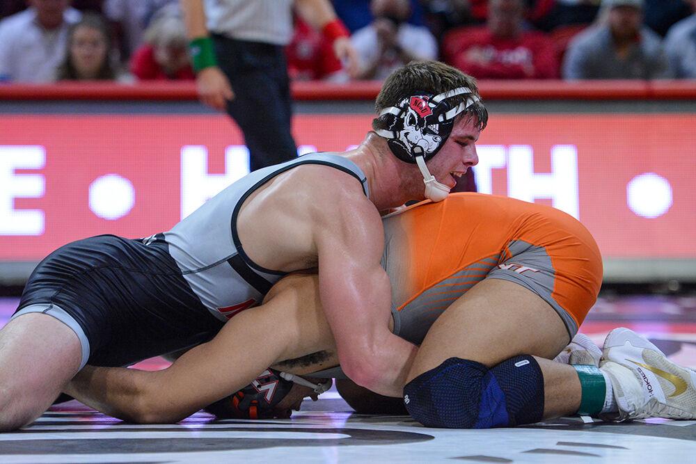 Freshman Isaac Trumble pins Virginia Tech's Dakota Howard in the 197 pound match. Trumble won 6-0 by decision. The Wolfpack won the home wrestling match against the Virginia Tech Hokies 21-10 at Reynolds Coliseum on Feb. 20, 2022. The Wolfpack also received the 2021-22 ACC dual champion trophy.