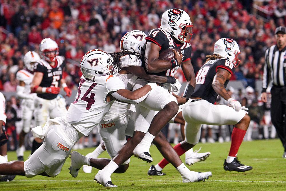 Graduate quarterback Jack Chambers runs down the field during the Wolfpack's game against the Virginia Tech Hokies on Thursday, Oct. 27, 2022 at Carter-Finley Stadium. The Wolfpack beat the Hokies 22-21.