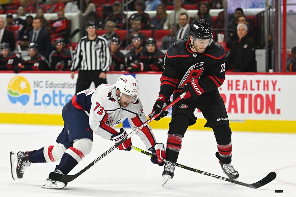Carolina Hurricanes defenseman Brett Pesce fights for the puck against a Washington Capitals opponent during the game on Monday, Oct. 31, 2022 in PNC Arena. The Hurricanes beat the Capitals 3-2.