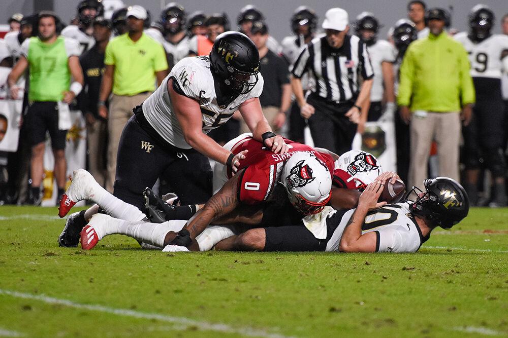Redshirt sophomore defensive tackle Joshua Harris sacks Wake Forest quarterback Sam Hartman in the game against the Demon Deacons on Saturday, Nov. 5, 2022 at Carter-Finley Stadium. The Pack beat the Demon Deacons 30-21.