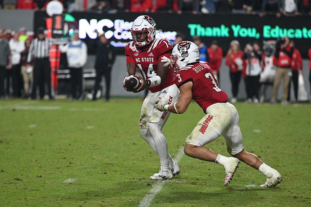 Graduate quarterback Jack Chambers hands the ball off to junior running back Jordan Houston during the Wolfpack's home football game against the Florida State Seminoles on Saturday, Oct. 8, 2022 at Carter-Finley Stadium. The Wolfpack beat the Seminoles 19-17.